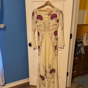 Elegant Ivory Long-Sleeve Evening Gown with Burgundy Floral Embellishments